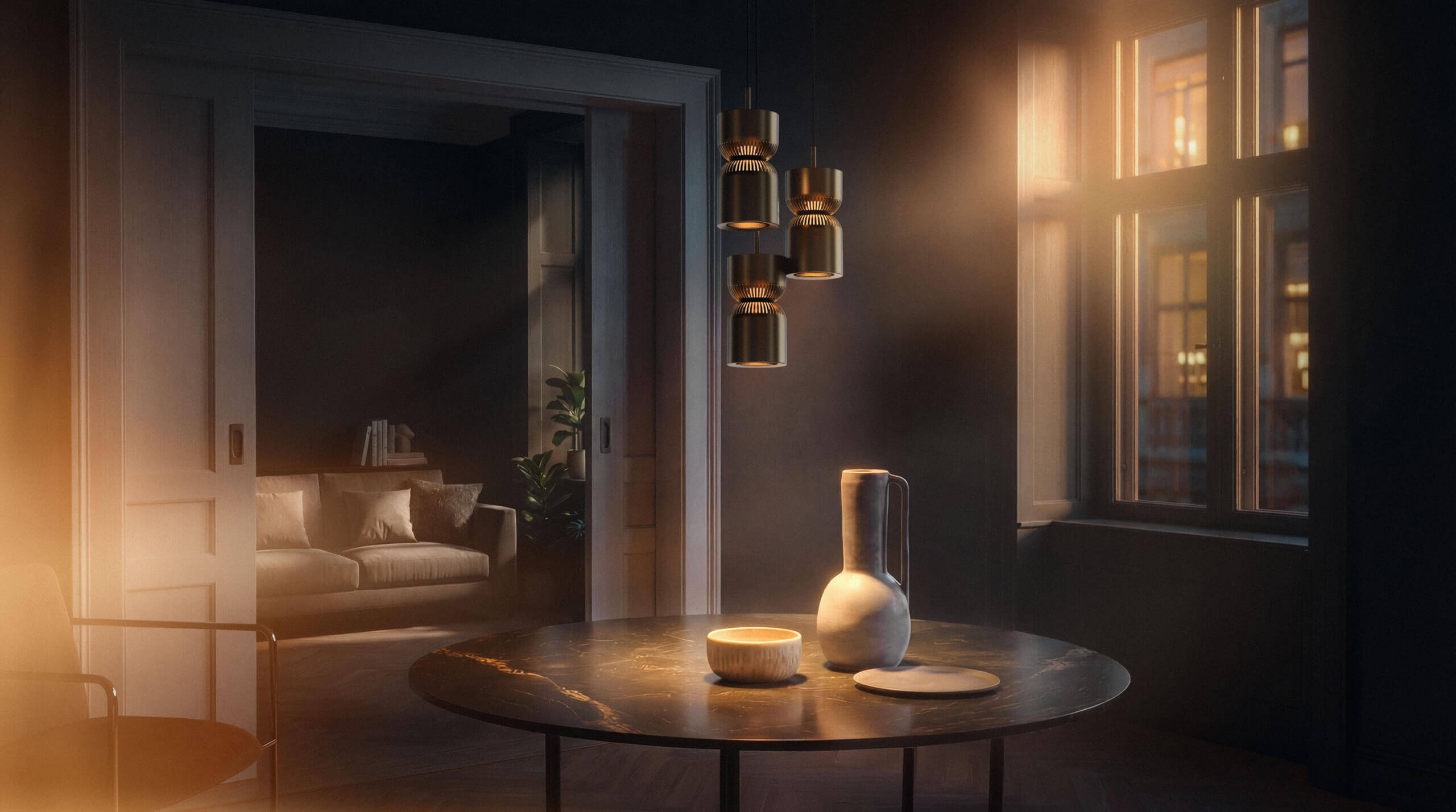 Three Belux "Moiré" pendant lights hang above a round table with a ceramic vase and bowl in a subdued room.